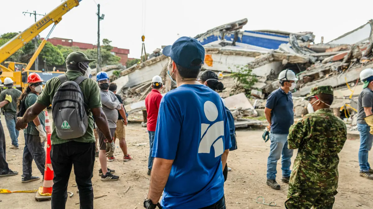 Americares responders survey the site of a collapsed building.