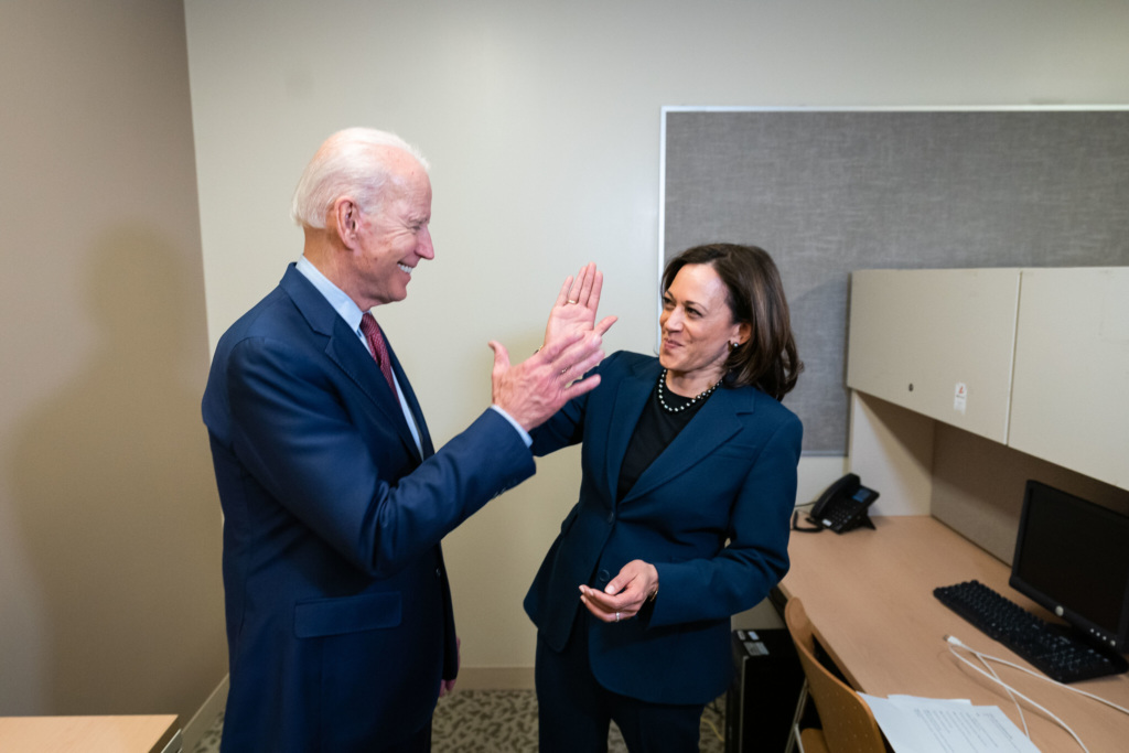 Joe Biden and Kamala Harris high-five in an office.