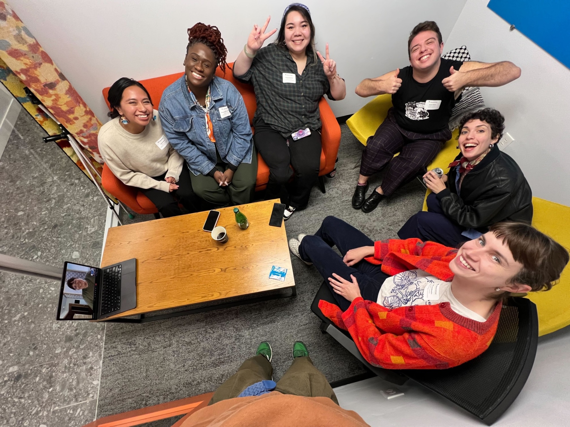 Six members of the graphics team sitting in a circle in an office during our 2024 Election events.