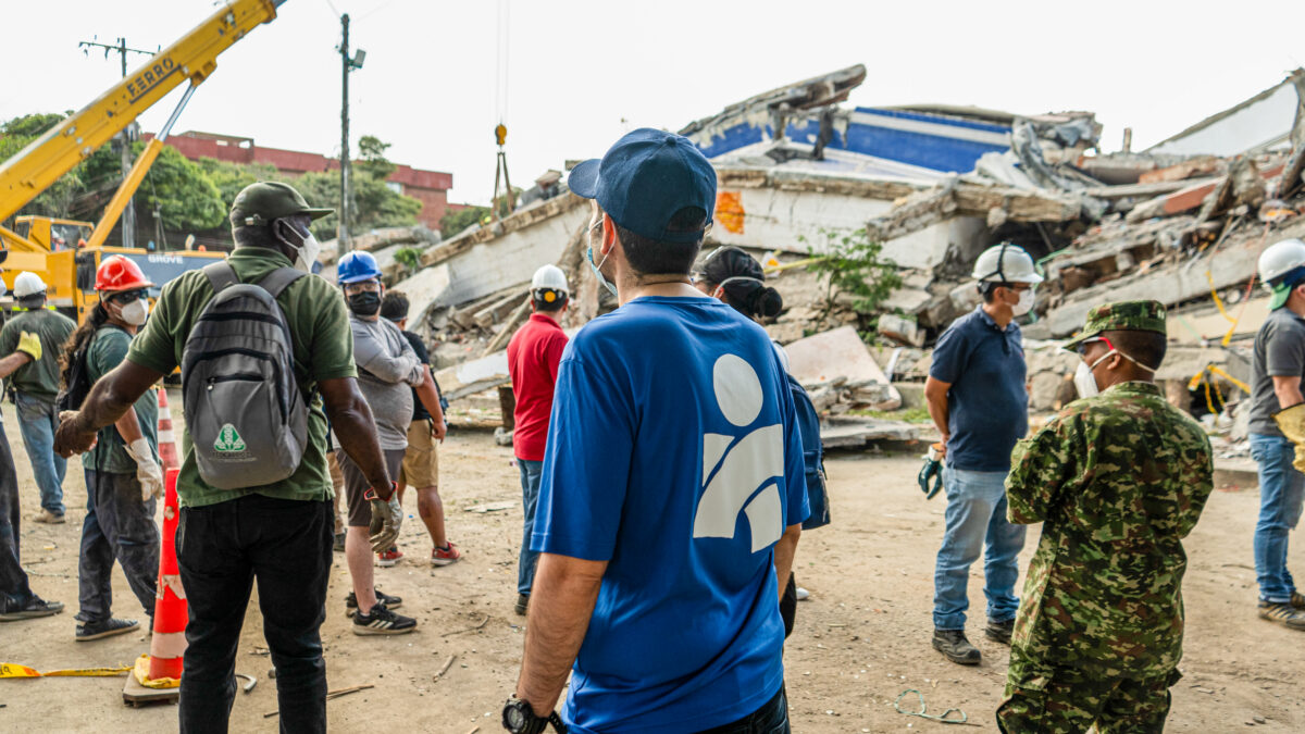 Americares responders survey the site of a collapsed building.