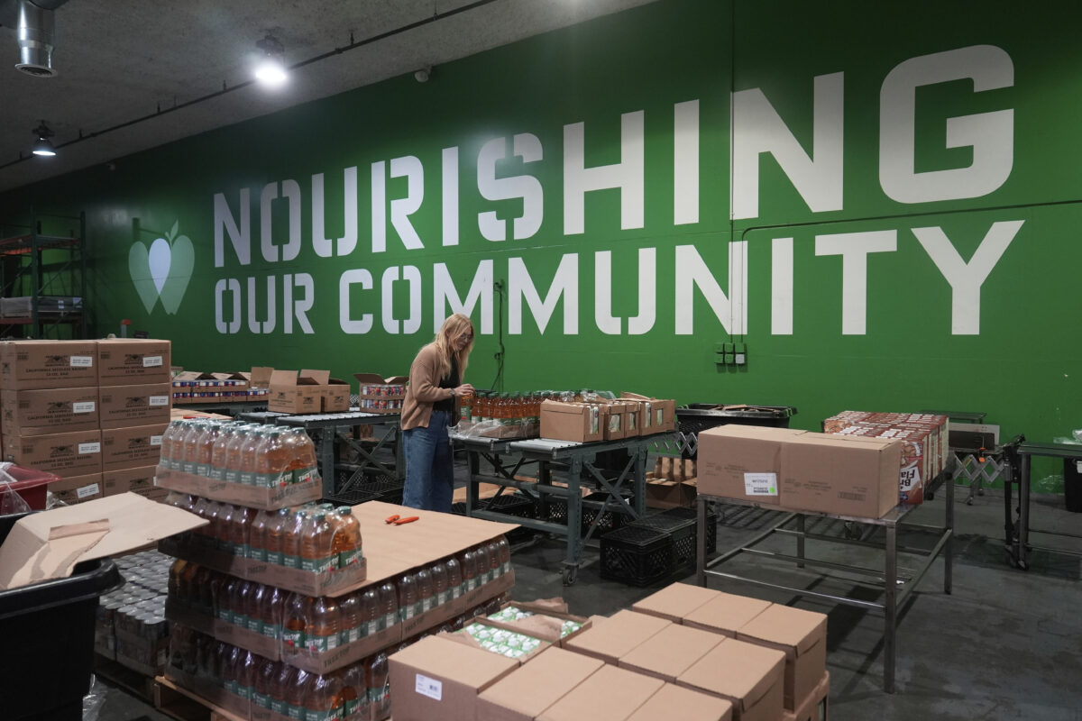 A volunteer packs food boxes at the San Francisco-Marin Food Bank warehouse.