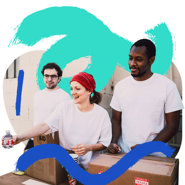 Volunteers pack aid boxes together.